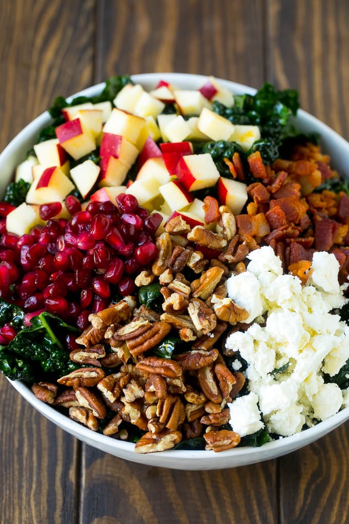 Apple Kale Salad Recipe | Kale Recipe | Fall Salad #kale #apples #bacon #salad #feta #dinner #lunch #bajap Kale salad topped with apples, bacon, pecans, pomegranate and feta cheese.