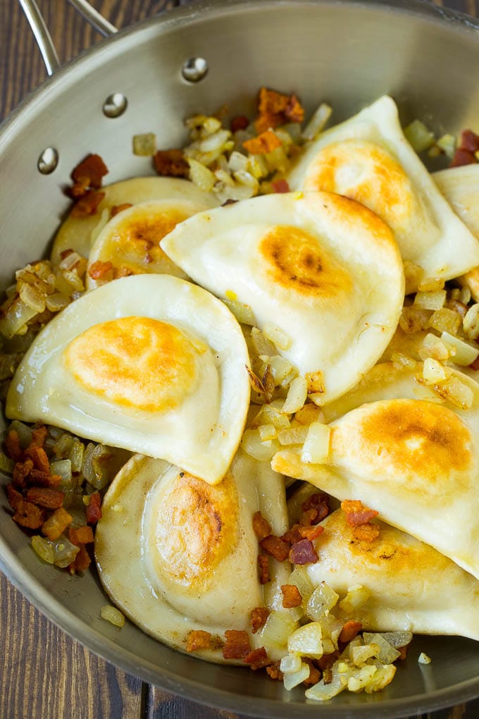 Pierogi Casserole Recipe | Potato Casserole #pierogis #casserole #bacon #cheddar #dinner #bajap Sauteed pierogis with bacon and onions in a skillet.