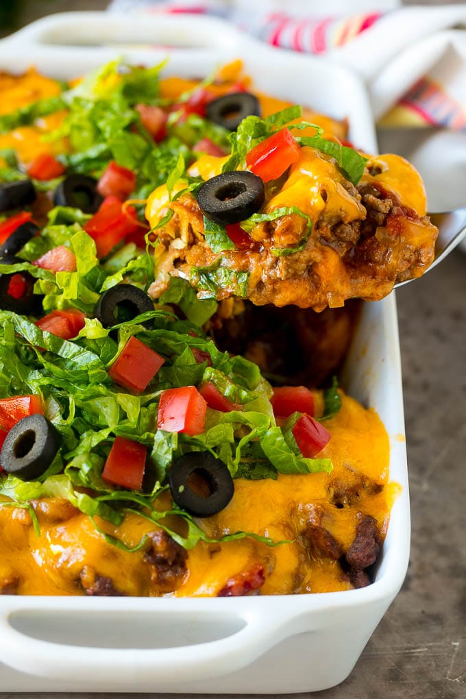 Taco Casserole Recipe | Mexican Casserole | Beef Casserole #casserole #tacos #beef #dinner #cheese #bajap A spoon serving up a portion of beef taco casserole.