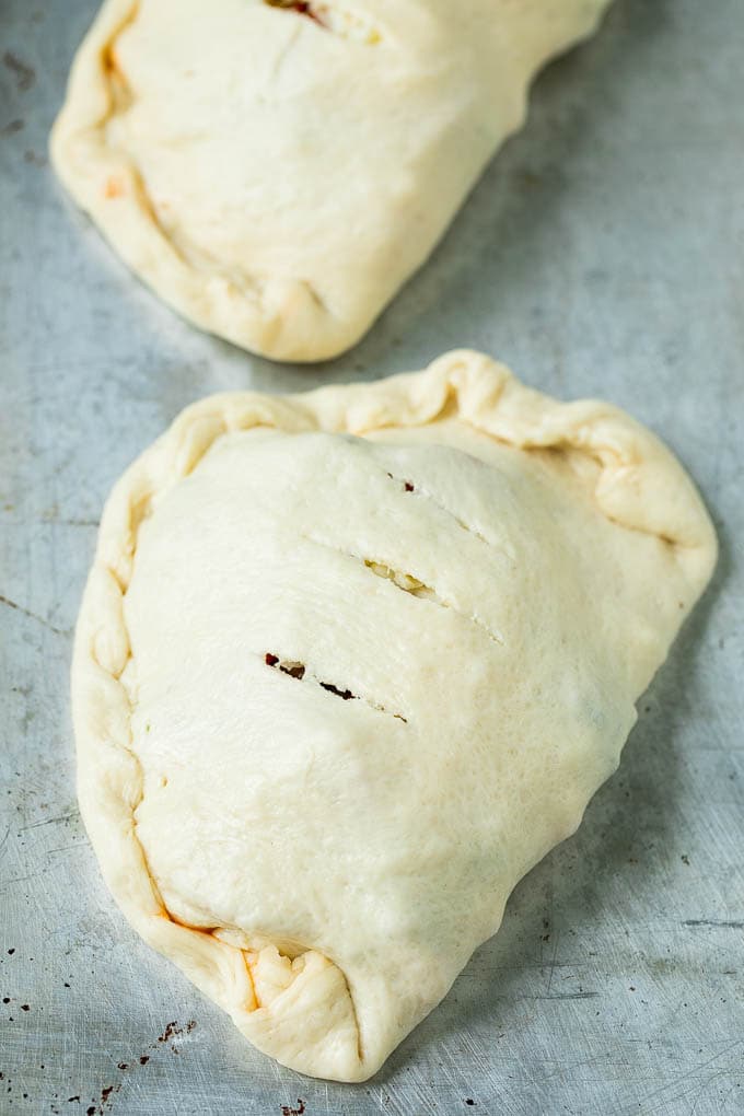 Calzone Recipe | Pizza Pockets #pizza #calzone #pepperoni #sausage #peppers #dinner #bajap #cheese Unbaked calzones ready to go into the oven.
