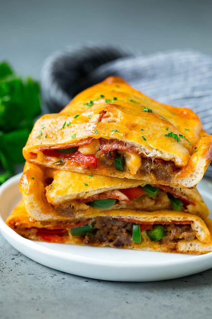 Calzone Recipe | Pizza Pockets #pizza #calzone #pepperoni #sausage #peppers #dinner #bajap #cheese Calzone halves stuffed with sausage, peppers, cheese and pepperoni.