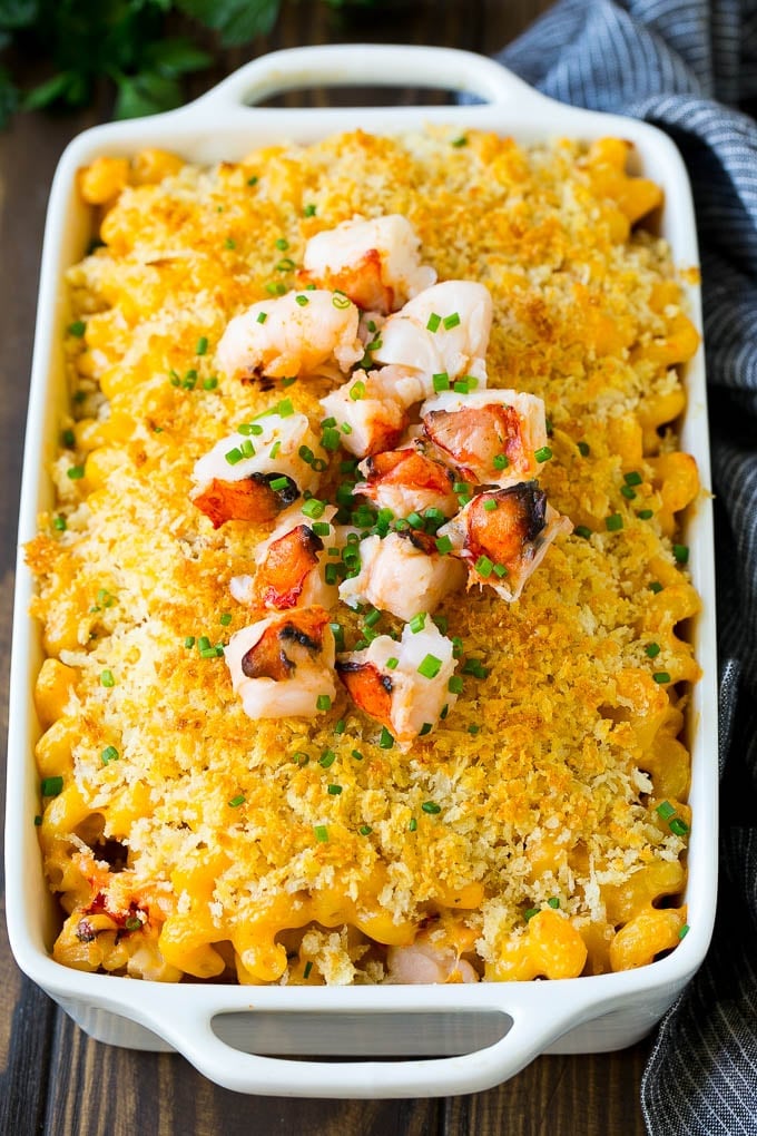 Lobster Mac and Cheese Recipe | Lobster Macaroni and Cheese | Baked Mac and Cheese #pasta #macandcheese #macaroni #lobster #cheese #dinner #bajap A baking dish of lobster macaroni and cheese, garnished with chopped lobster meat.