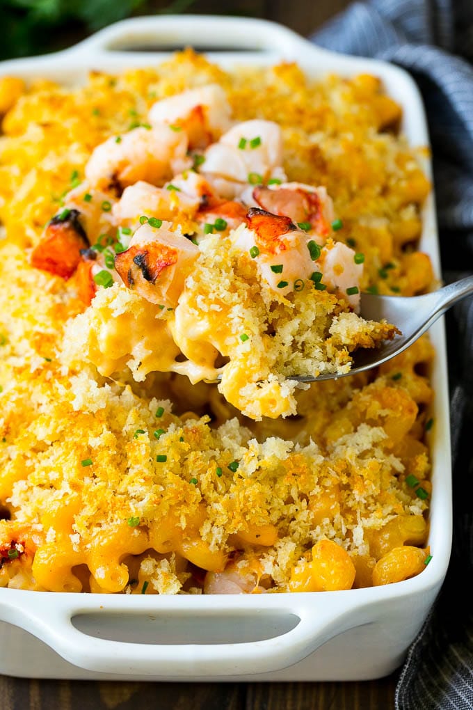 Lobster Mac and Cheese Recipe | Lobster Macaroni and Cheese | Baked Mac and Cheese #pasta #macandcheese #macaroni #lobster #cheese #dinner #bajap A spoon serving up a portion of lobster mac and cheese.