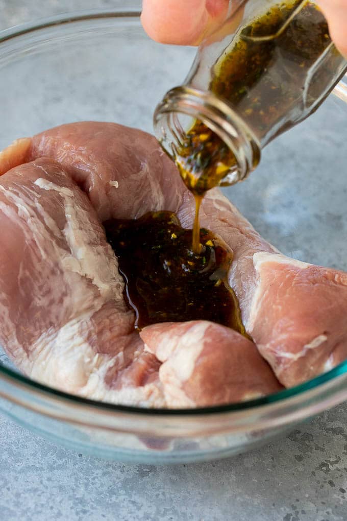 Marinated Pork Tenderloin Recipe | Pork Tenderloin Marinade | Pork Marinade #pork #porktenderloin #marinade #dinner #grilling #bajap Marinade being poured over pork tenderloin.
