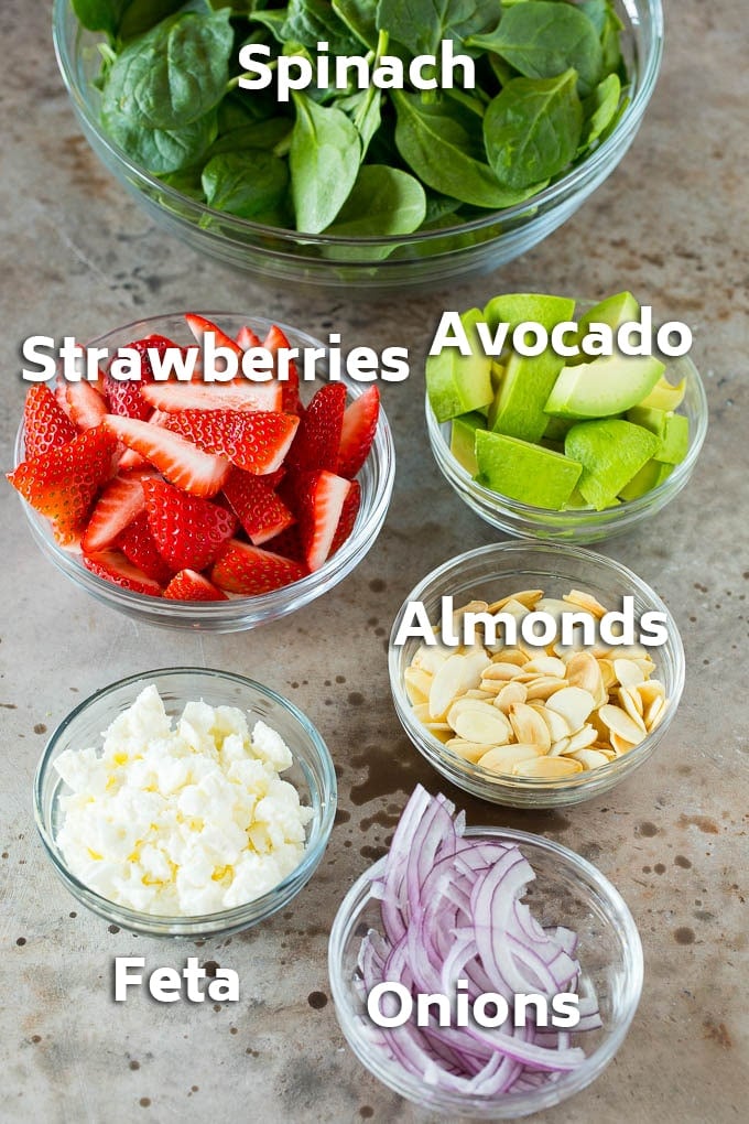 Strawberry Spinach Salad Recipe | Strawberry Salad | Spinach Salad #spinach #salad #strawberries #avocado #bajap Bowls of ingredients like feta cheese, almonds, red onion and avocado.