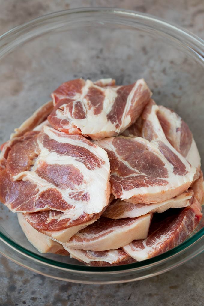 Tacos al Pastor Recipe | Pork Tacos | Mexican Tacos #tacos #pork #pineapple #grilling #tacotuesday #dinner #bajap Sliced pork shoulder in a bowl.