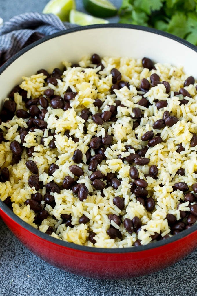 Black Beans and Rice Recipe | Cuban Black Beans | Beans and Rice #beans #rice #blackbeans #sidedish #glutenfree #dinner #bajap Rice and beans mixed together in a red pot.