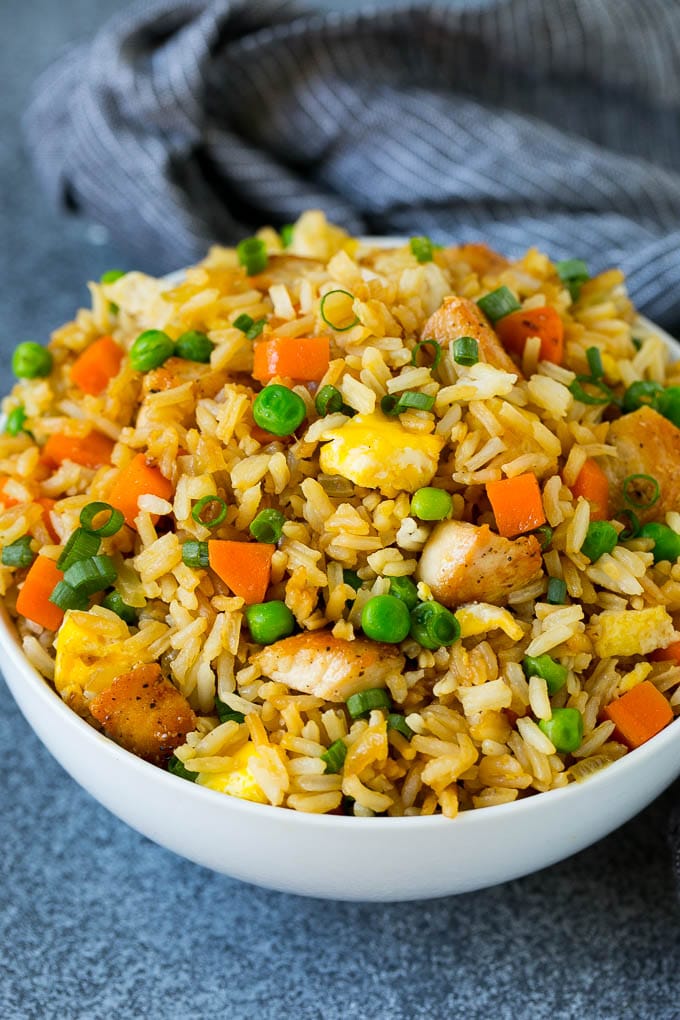 Chicken Fried Rice Recipe | Chinese Fried Rice #rice #chicken #peas #carrots #sidedish #dinner #bajap A bowl of chicken fried rice topped with sliced green onions.