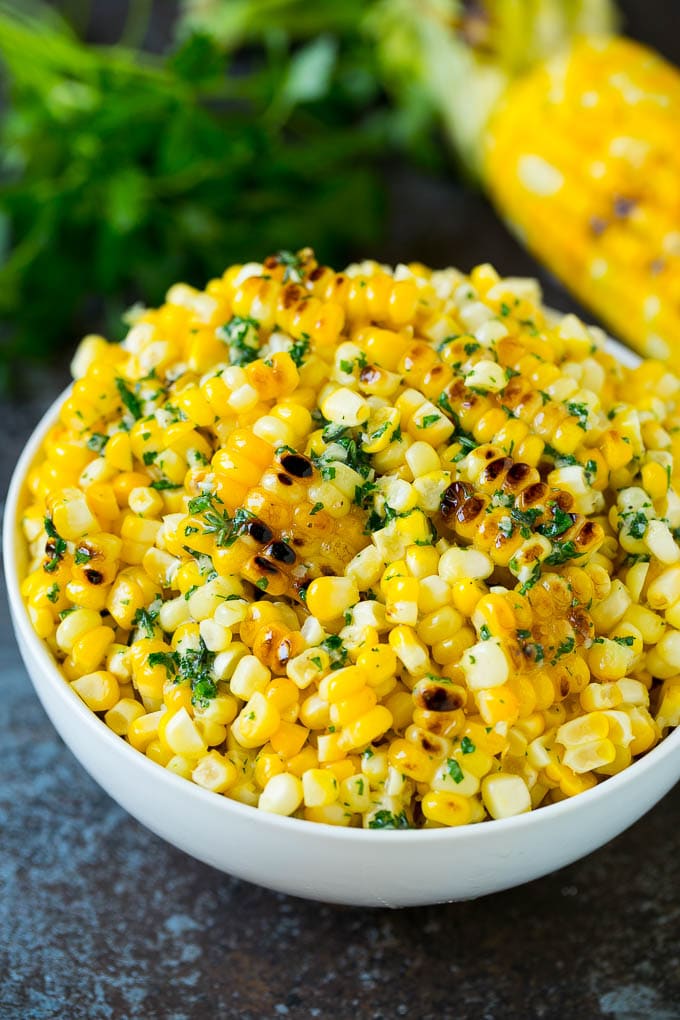 Grilled Corn on the Cob Recipe | Corn Recipe #corn #grilling #summer #sidedish #dinner #bajap Grilled corn cut off the cob with herb butter in a bowl.