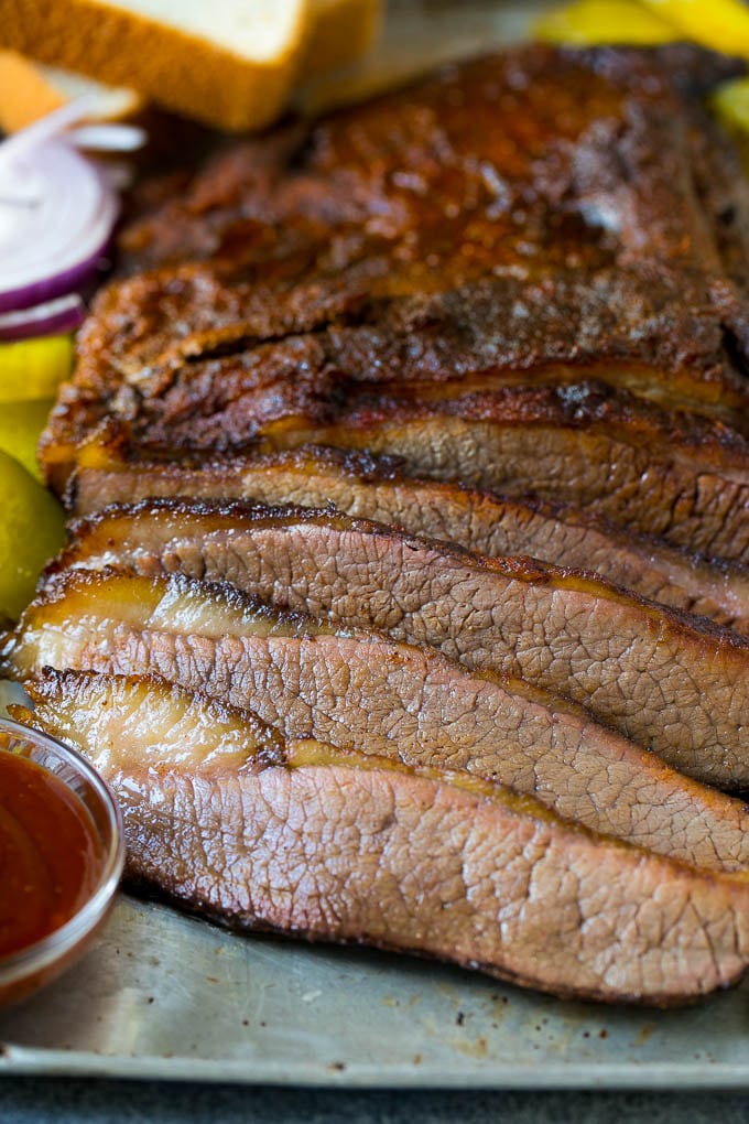 Smoked Brisket Recipe | Beef Brisket | BBQ Beef #brisket #smoker #beef #bbq #dinner #bajap Sliced smoked brisket with a side of BBQ sauce.