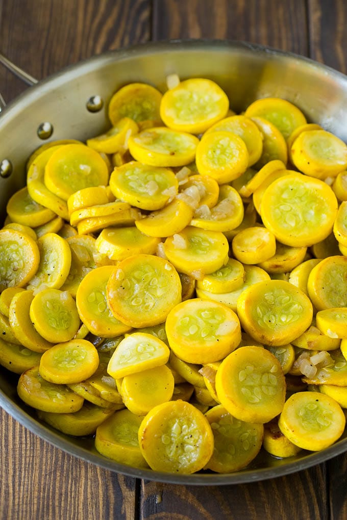 Squash Casserole Recipe | Vegetable Casserole | Zucchini Casserole #casserole #squash #zucchini #cheese #sidedish #bajap Yellow squash and onions in a frying pan.