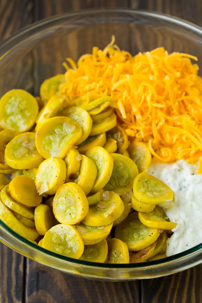 Squash Casserole Recipe | Vegetable Casserole | Zucchini Casserole #casserole #squash #zucchini #cheese #sidedish #bajap Cooked yellow squash, creamy sauce and cheddar cheese in a mixing bowl.