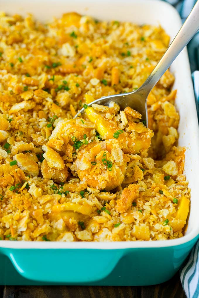 Squash Casserole Recipe | Vegetable Casserole | Zucchini Casserole #casserole #squash #zucchini #cheese #sidedish #bajap A serving spoon in a dish of squash casserole.
