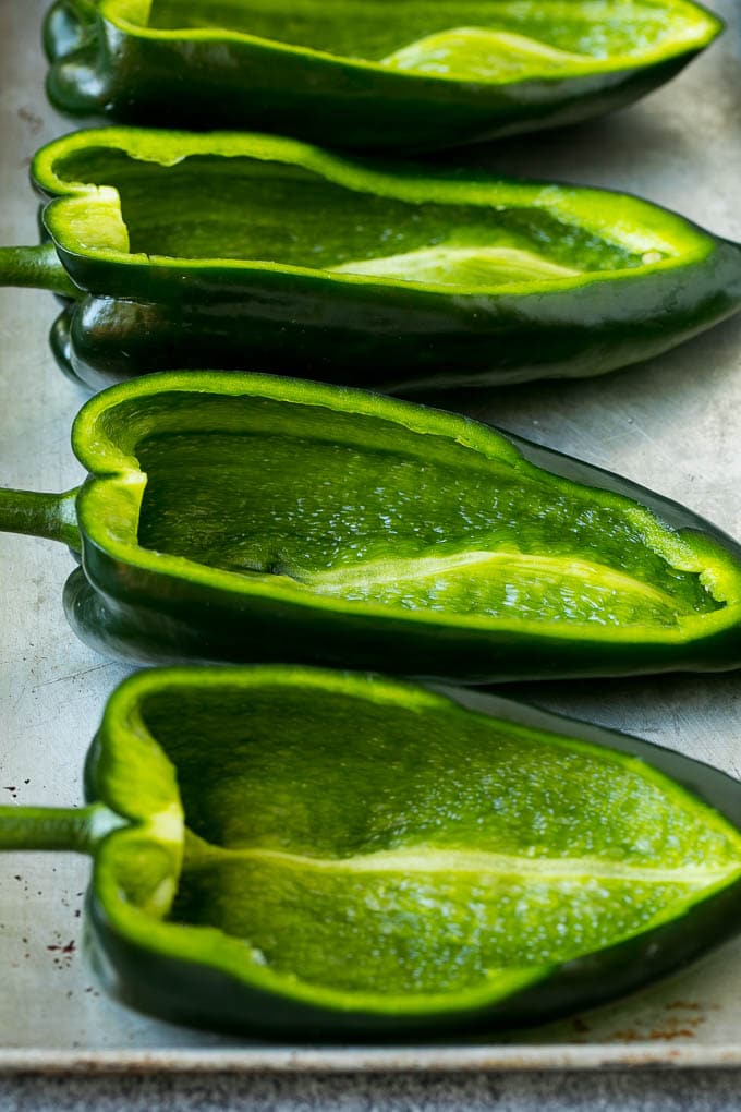 Stuffed Poblano Peppers | Stuffed Peppers | Pasilla Peppers #peppers #stuffedpeppers #beef #rice #beans #corn #dinner #bajap Hollowed out poblano peppers on a pan.