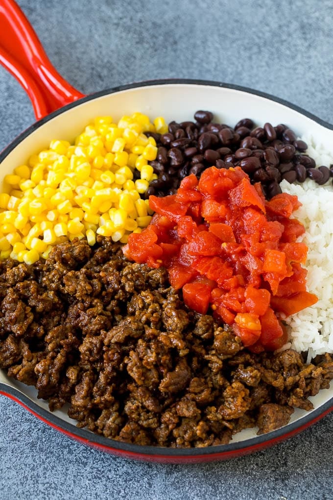 Stuffed Poblano Peppers | Stuffed Peppers | Pasilla Peppers #peppers #stuffedpeppers #beef #rice #beans #corn #dinner #bajap A skillet filled with ground beef, rice, tomatoes, beans and corn.