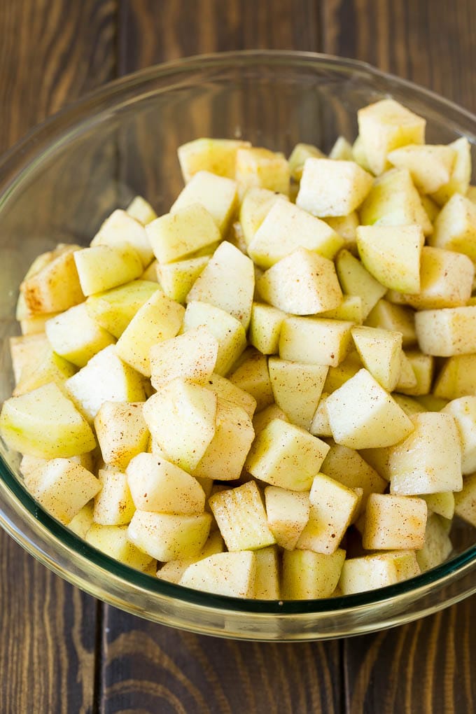 Apple Crisp Recipe | Apple Dessert #apples #dessert #baking #fall #bajap Diced apples tossed with sugar and cinnamon in a bowl.