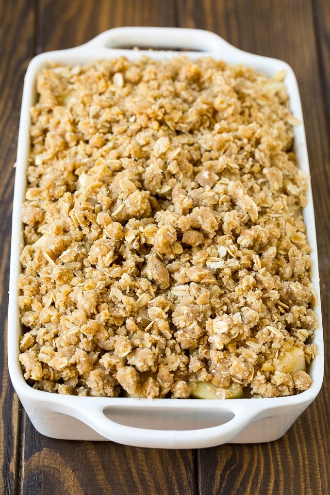 Apple Crisp Recipe | Apple Dessert #apples #dessert #baking #fall #bajap Apples in a baking dish topped with brown sugar crumble.