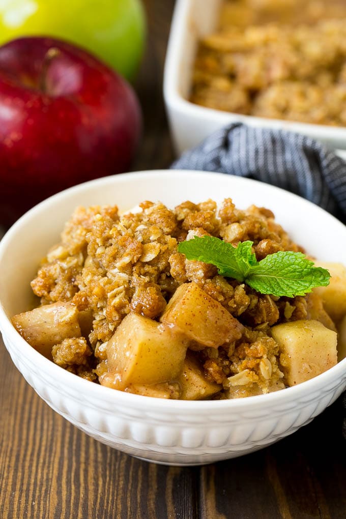 Apple Crisp Recipe | Apple Dessert #apples #dessert #baking #fall #bajap A bowl of apple crisp garnished with a sprig of mint.