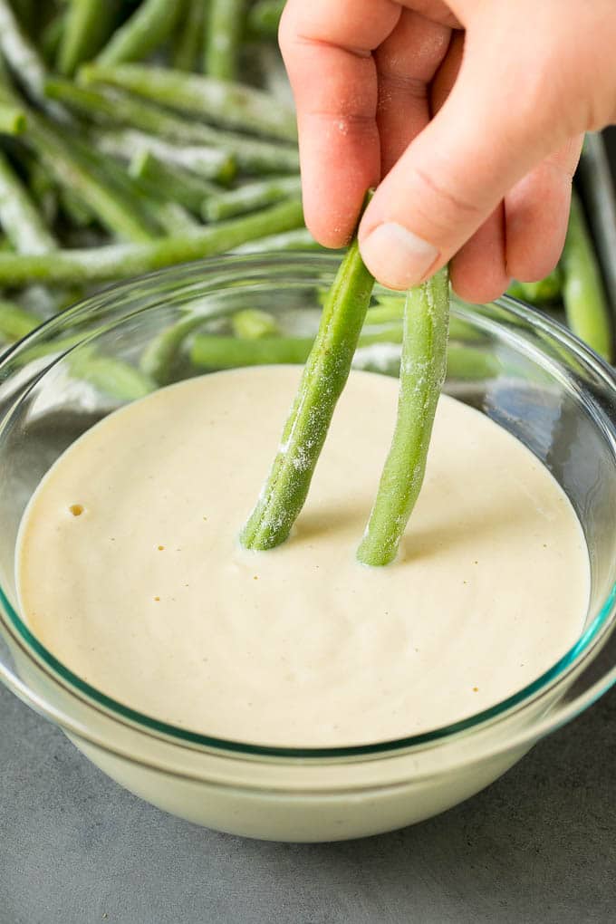 Fried Green Beans Recipe | Green Beans #greenbeans #appetizer #snack #bajap A hand dipping beans into beer batter.