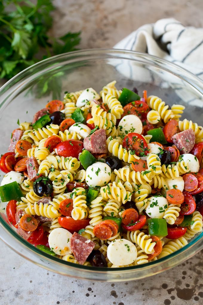 Italian Pasta Salad | Pasta Salad Recipe #pasta #salad #pastasalad #pepperoni #salami #olives #cheese #sidedish #bajap A bowl of Italian pasta salad filled with meats, cheese and vegetables.
