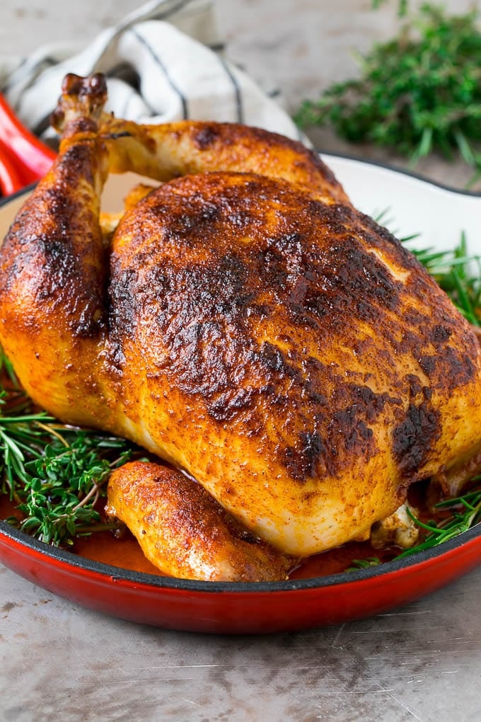 Rotisserie Chicken Recipe | Roasted Chicken #chicken #dinner #bajap #comfortfood Rotisserie chicken in a skillet garnished with fresh herbs.