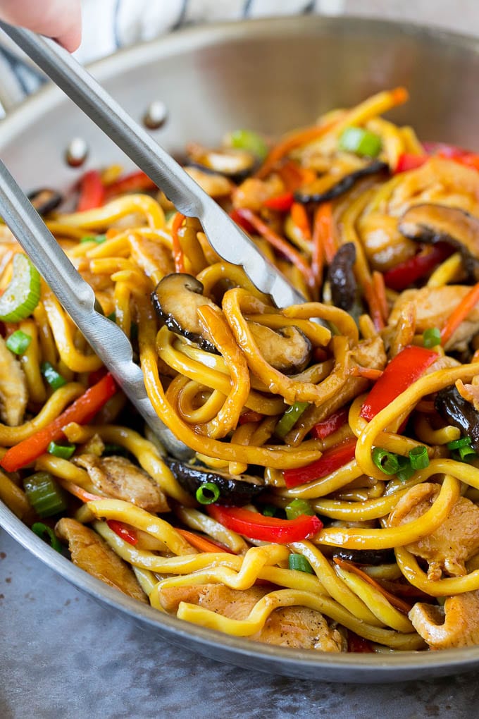 Stir Fry Noodles Recipe | Noodle Stir Fry #chicken #noodles #stirfry #mushrooms #dinner #bajap Tongs serving up a portion of chicken and noodle stir fry.