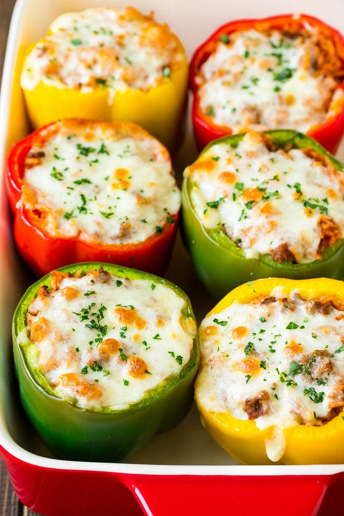 Stuffed Bell Peppers Recipe | Stuffed Peppers #beef #rice #peppers #dinner #cheese #bajap Stuffed bell peppers in a baking dish topped with melted cheese.