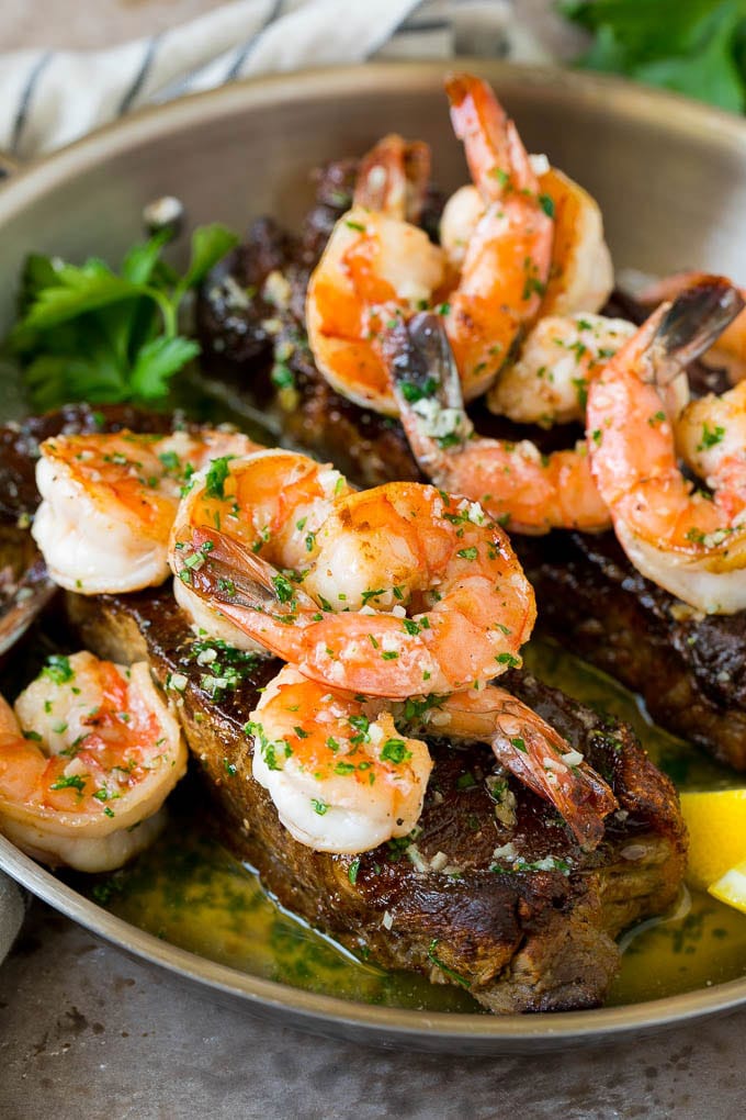 Surf and Turf Recipe | Seared Steak #steak #shrimp #keto #lowcarb #dinner #bajap Surf and turf with seared strip steaks topped with jumbo shrimp in garlic butter.