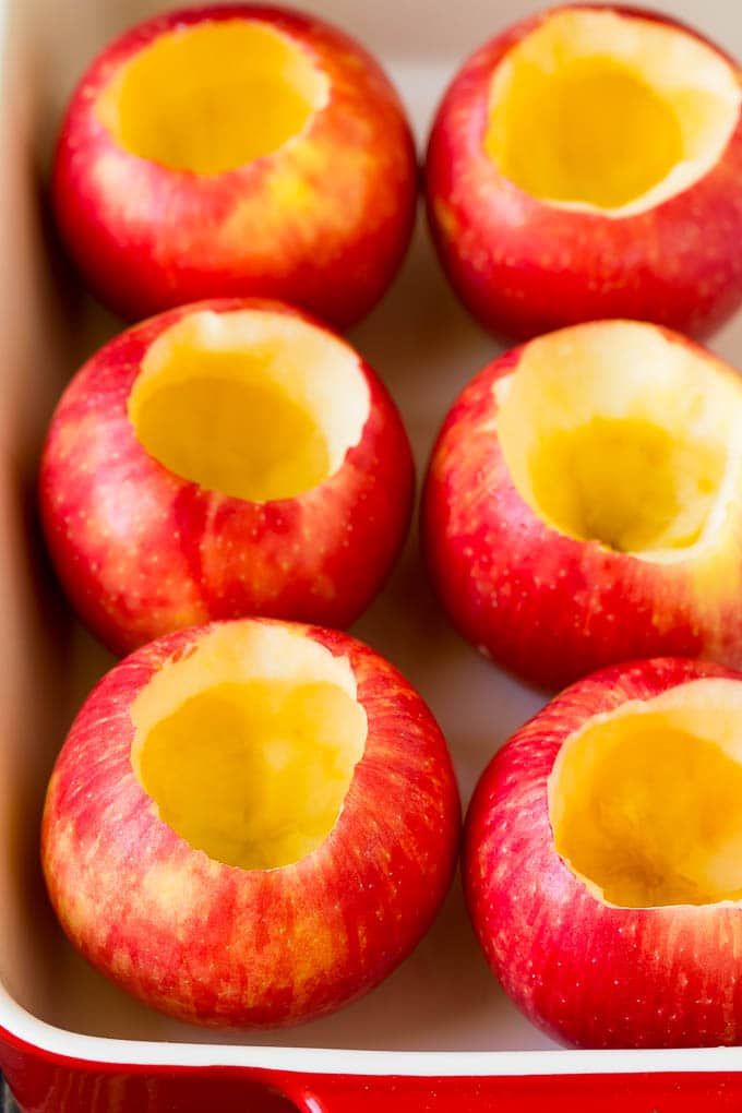 Baked Apples | Stuffed Apples #apples #fall #dessert #sweettooth #bajap Hollowed out apples in a baking dish.