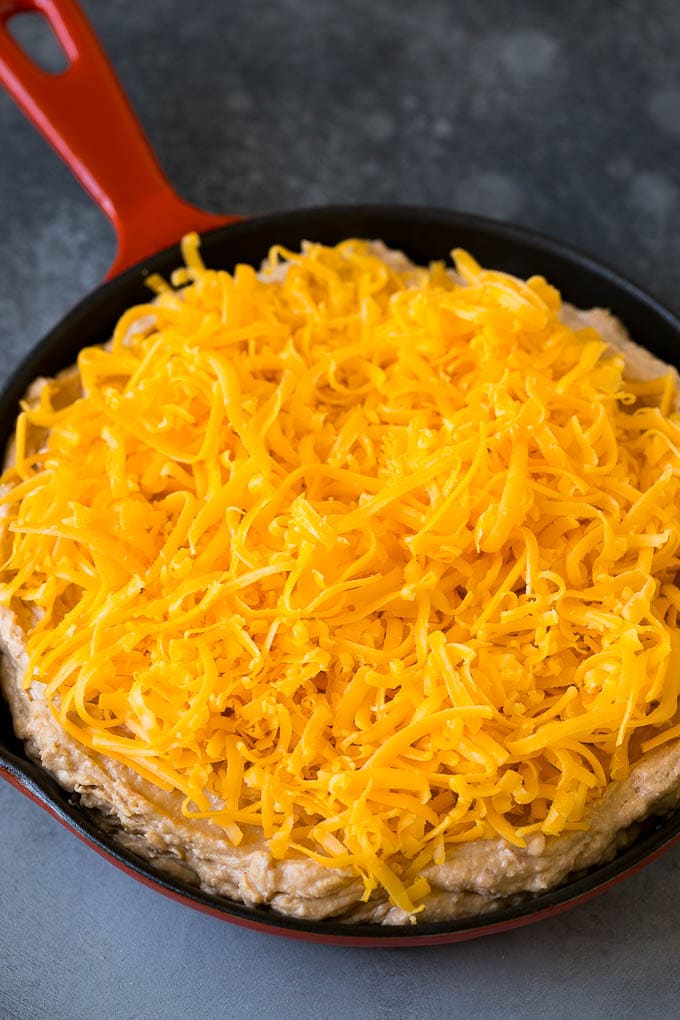 Bean Dip Recipe | Mexican Dip #dip #appetizer #mexicanfood #beans #cheese #bajap The base topped with freshly shredded cheese.