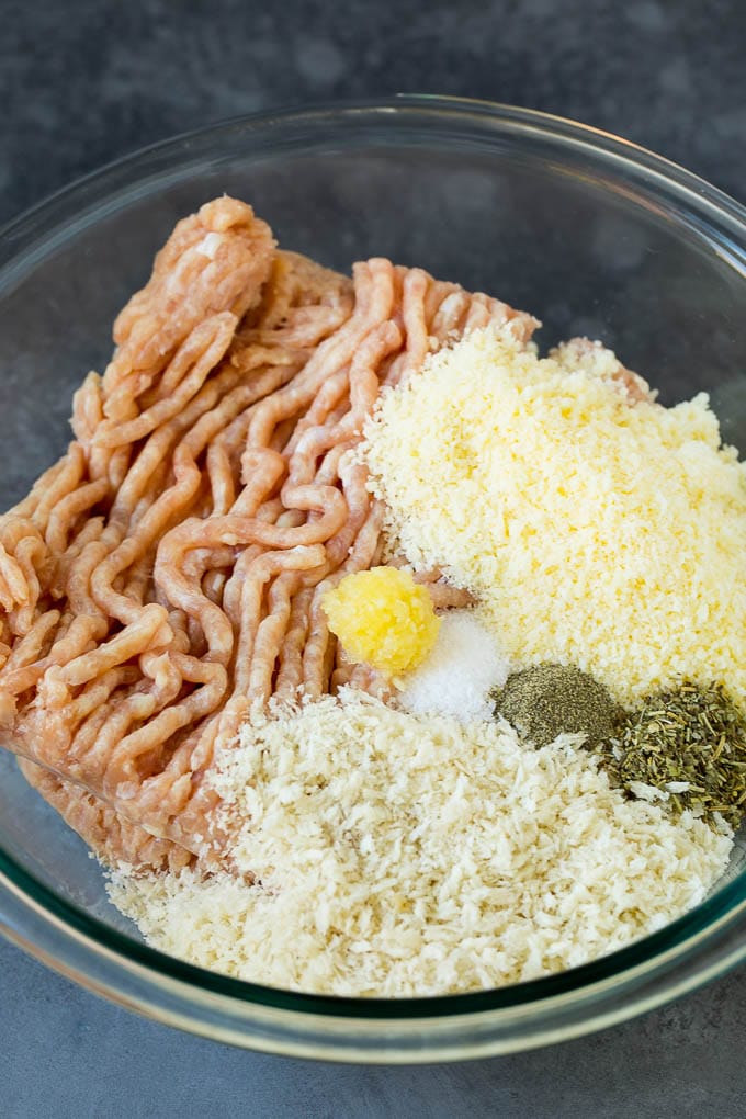 Chicken Meatballs Recipe | Baked Meatballs #chicken #meatballs #dinner #bajap #comfortfood Ground chicken, herbs, breadcrumbs and cheese in a mixing bowl.