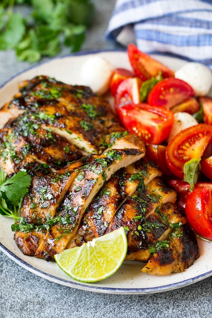 Grilled Chicken Thighs Recipe | Marinated Chicken Thighs #chicken #grilling #marinade #dinner #cilantro #lime #bajap Sliced chicken thighs served with tomato salad.