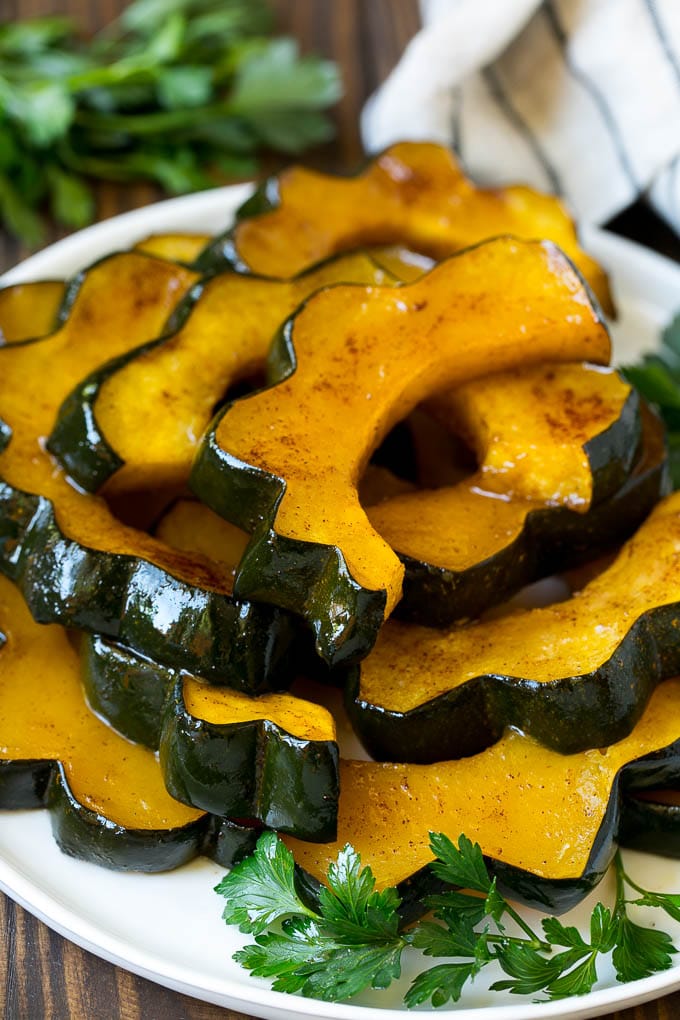 Roasted Acorn Squash | Acorn Squash Recipe #squash #winter #sidedish #dinner #bajap A serving plate of roasted acorn squash.