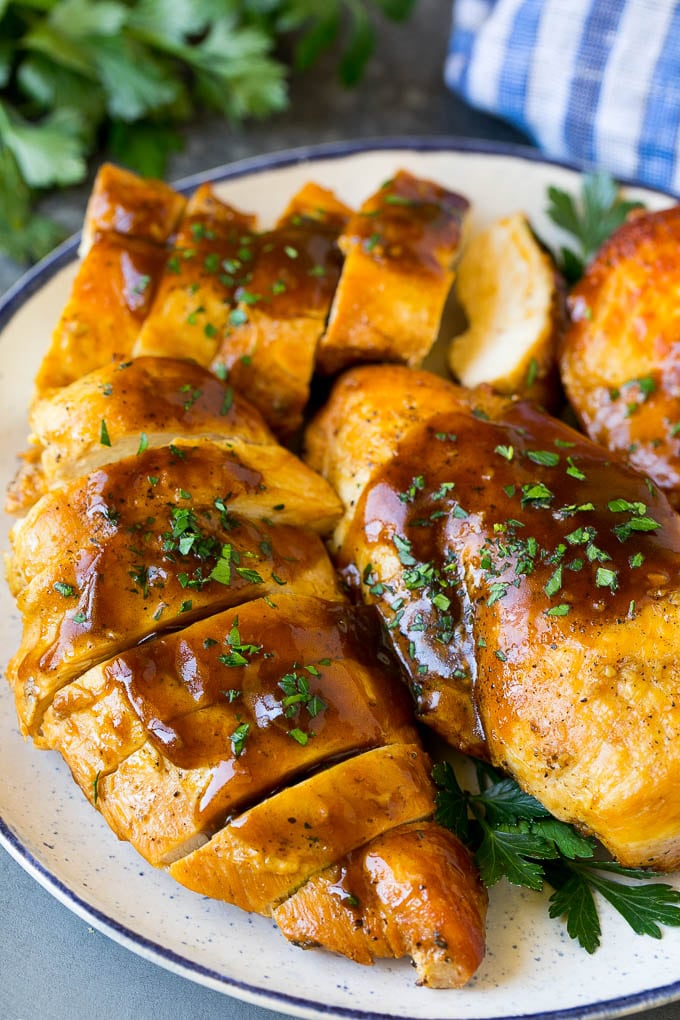 Slow Cooker Chicken Breast Recipe | Crock Pot Chicken Breast | Chicken and Gravy #chicken #slowcooker #crockpot #gravy #dinner #bajap Sliced crock pot chicken breasts on a serving plate.