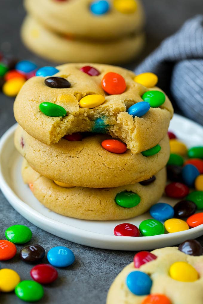 M&M Cookies Recipe #cookies #chocolate #baking #dessert #sweets #bajap A stack of M&M cookies with a bite taken out of one.