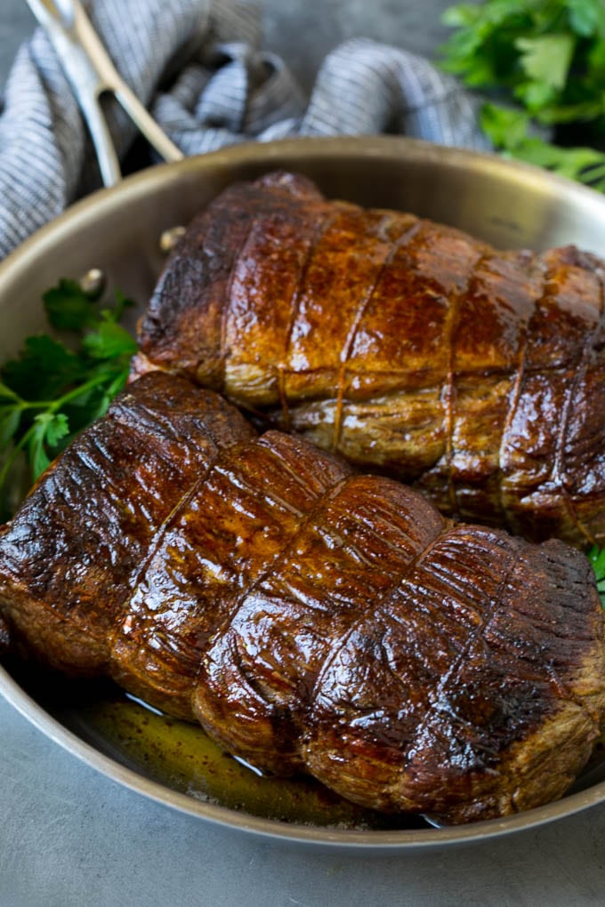 Beef Tenderloin with Garlic Butter #beef #steak #dinner #bajap Roasted garlic butter beef tenderloin in a pan.