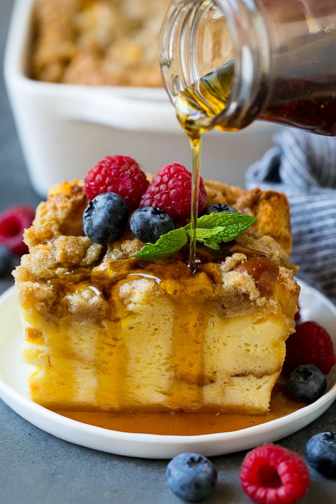 French Toast Casserole Recipe | French Toast Bake #frenchtoast #casserole #breakfast #brunch #bajap #bread A piece of french toast casserole with syrup being poured over the top.