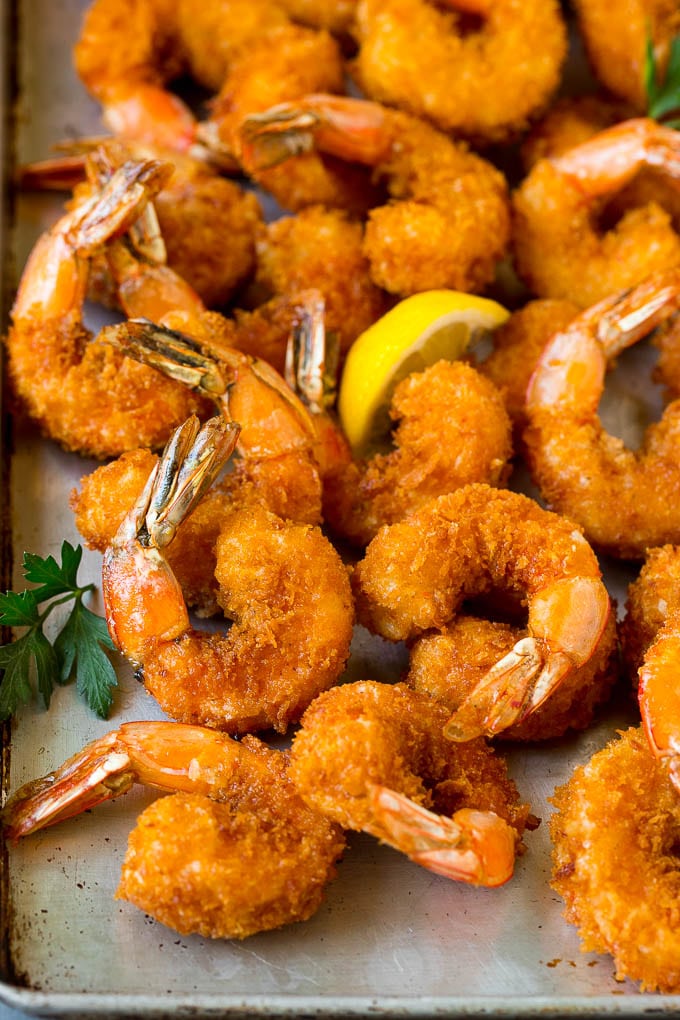 Fried Shrimp Recipe #shrimp #seafood #dinner #appetizer #bajap Fried shrimp on a sheet pan garnished with parsley and lemon.