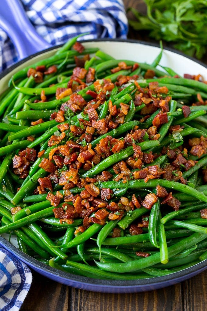 Green Beans with Bacon Recipe | Bacon Green Beans #bacon #greenbeans #sidedish #thanksgiving #veggies #dinner #bajap Green beans with bacon in a skillet, topped with parsley.