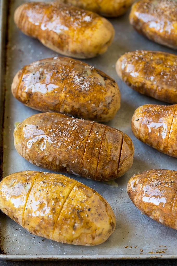 Hasselback Potatoes Recipe #potatoes #bacon #sidedish #cheese #dinner #bajap Potatoes on a sheet pan coated in olive oil and butter.