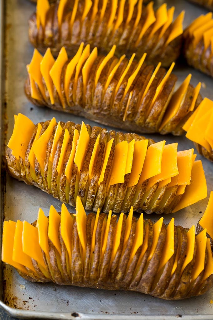 Hasselback Potatoes Recipe #potatoes #bacon #sidedish #cheese #dinner #bajap Thinly sliced potatoes with slices of cheese in between the cuts.