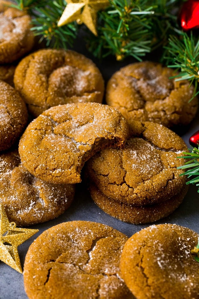 Molasses Cookies Recipe | Spice Cookies #cookies #baking #christmas #dessert #bajap Molasses cookies coated in sugar, surrounded by holiday decorations.