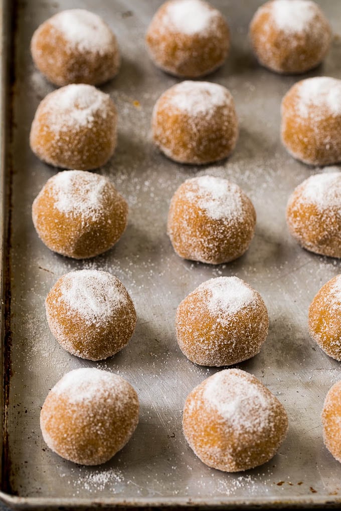 Molasses Cookies Recipe | Spice Cookies #cookies #baking #christmas #dessert #bajap Balls of cookie dough rolled in sugar on a sheet pan.