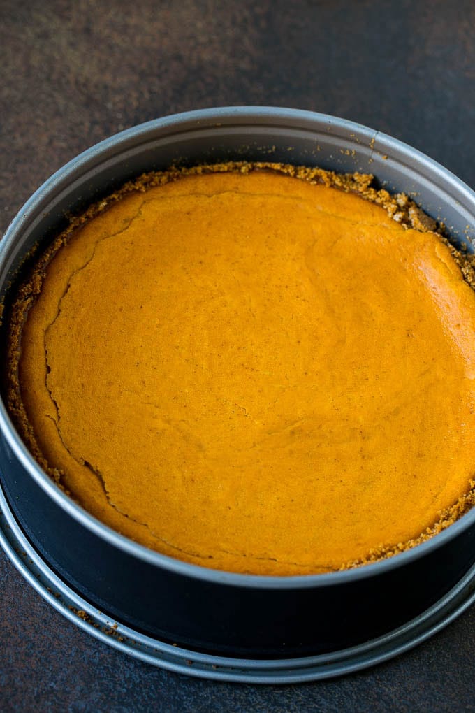 Pumpkin Pie Cheesecake Recipe | Pumpkin Cheesecake #cake #cheesecake #pumpkin #fall #thanksgiving #dessert #bajap A baked pumpkin cheesecake in a pan.