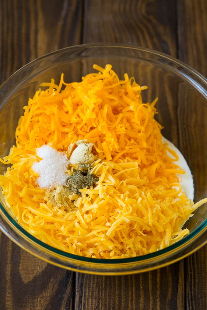 Southern Mac and Cheese | Baked Macaroni and Cheese #pasta #macandcheese #dinner #comfortfood #cheese #bajap A bowl of milk, cream, two types of shredded cheese and seasonings.