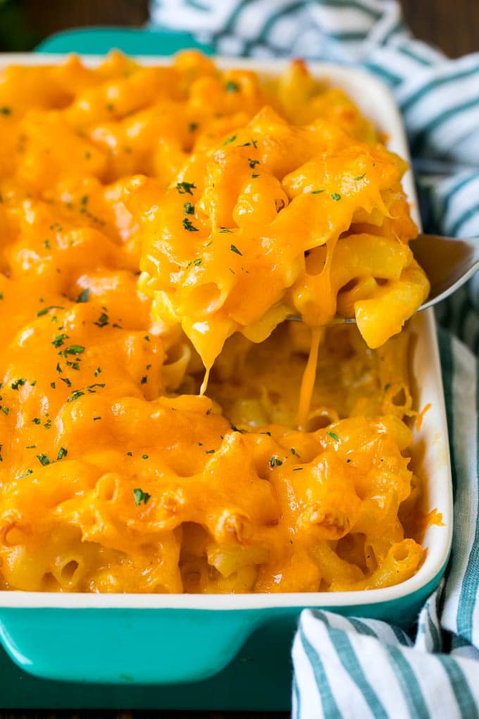 Southern Mac and Cheese | Baked Macaroni and Cheese #pasta #macandcheese #dinner #comfortfood #cheese #bajap A spoon serving up a portion of Southern mac and cheese.