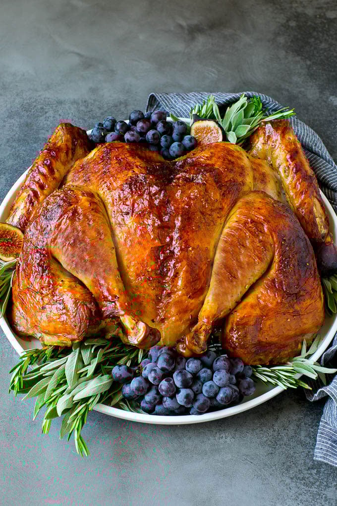 Spatchcock Turkey | Roasted Turkey | Thanksgiving Turkey #turkey #thanksgiving #dinner #fall #christmas #bajap Spatchcock turkey garnished with grapes and fresh herbs.