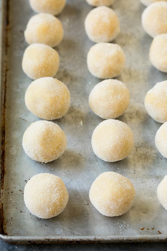 Thumbprint Cookies | Sugar Cookies #cookies #baking #christmas #dessert #bajap Balls of cookie dough rolled in sugar.