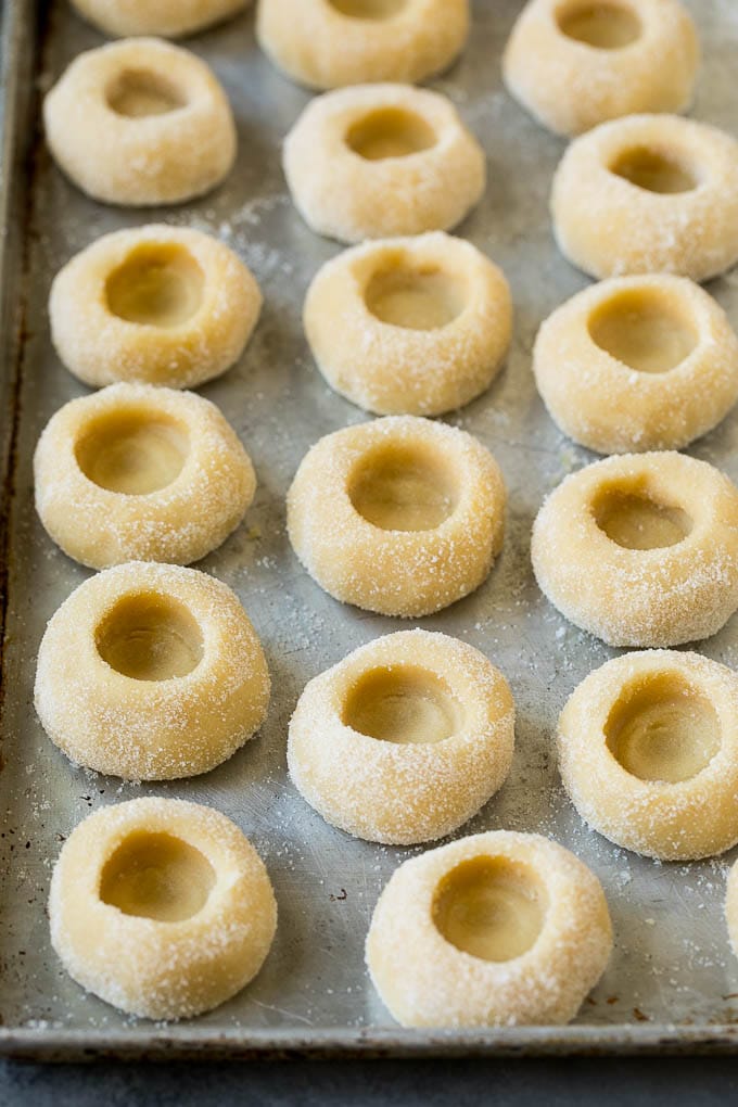 Thumbprint Cookies | Sugar Cookies #cookies #baking #christmas #dessert #bajap Balls of cookie dough with indentations in them.
