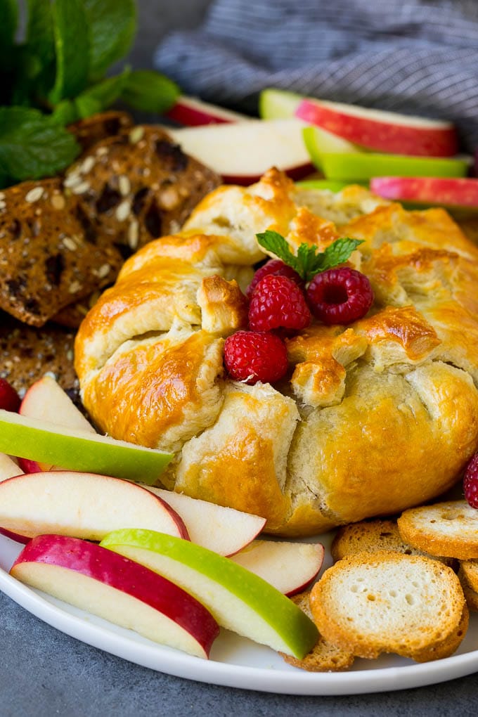 Baked Brie Recipe | Pastry Wrapped Brie #brie #cheese #appetizer #pecans #raspberries #bajap Brie wrapped in puff pastry, served with apples and crackers.